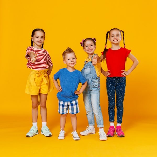 Group,Of,Cheerful,Happy,Children,On,A,Colored,Yellow,Background